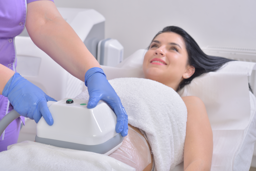 EMSculpt NEO session in progress for abdominal fat reduction.