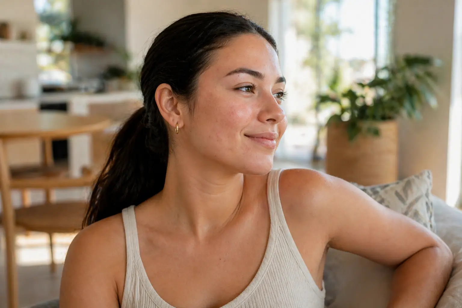 Woman with clear skin looking to the side in natural light